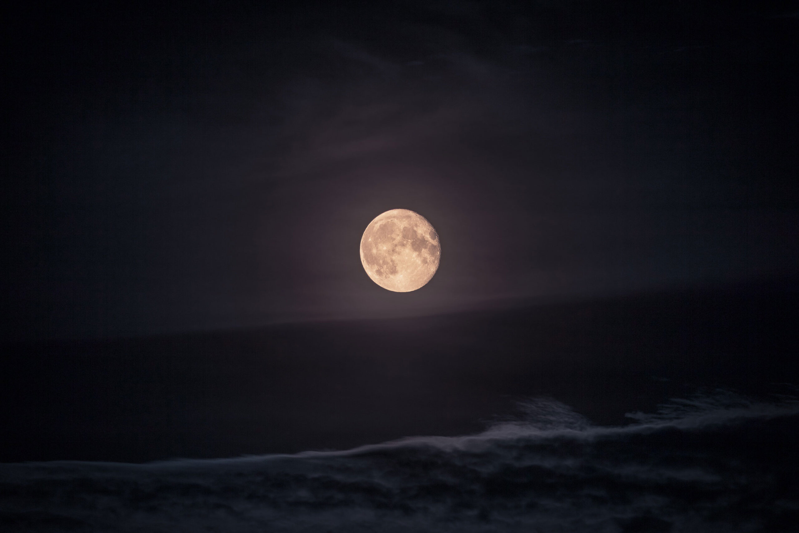 Full moon over the ocean.