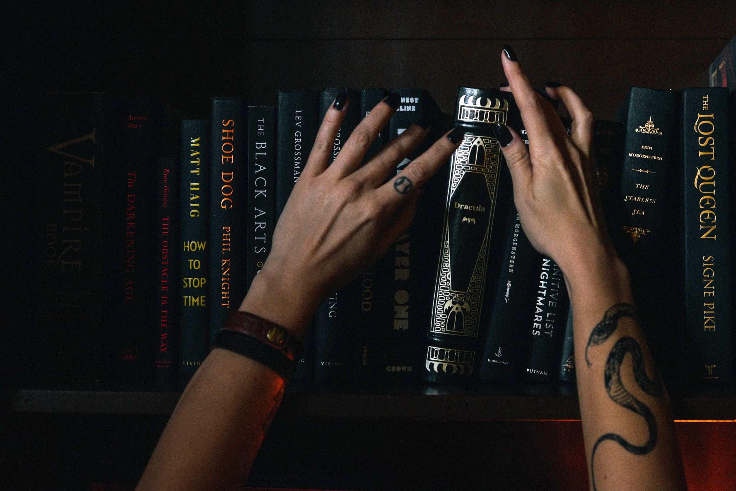 Hands reaching for occult books