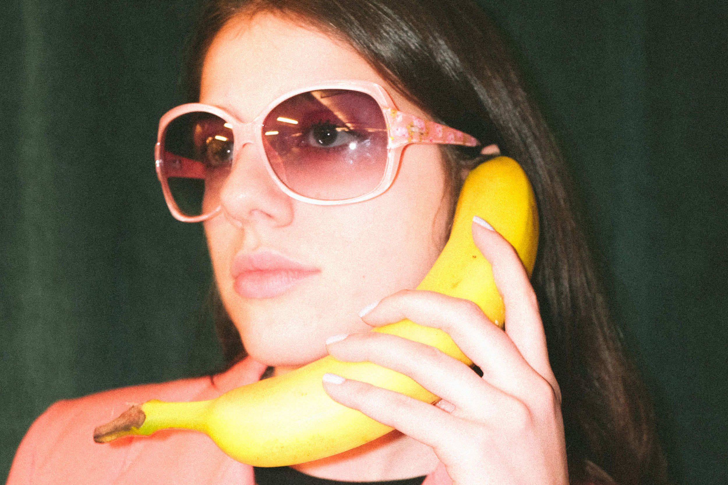 Woman holding a banana like a phone