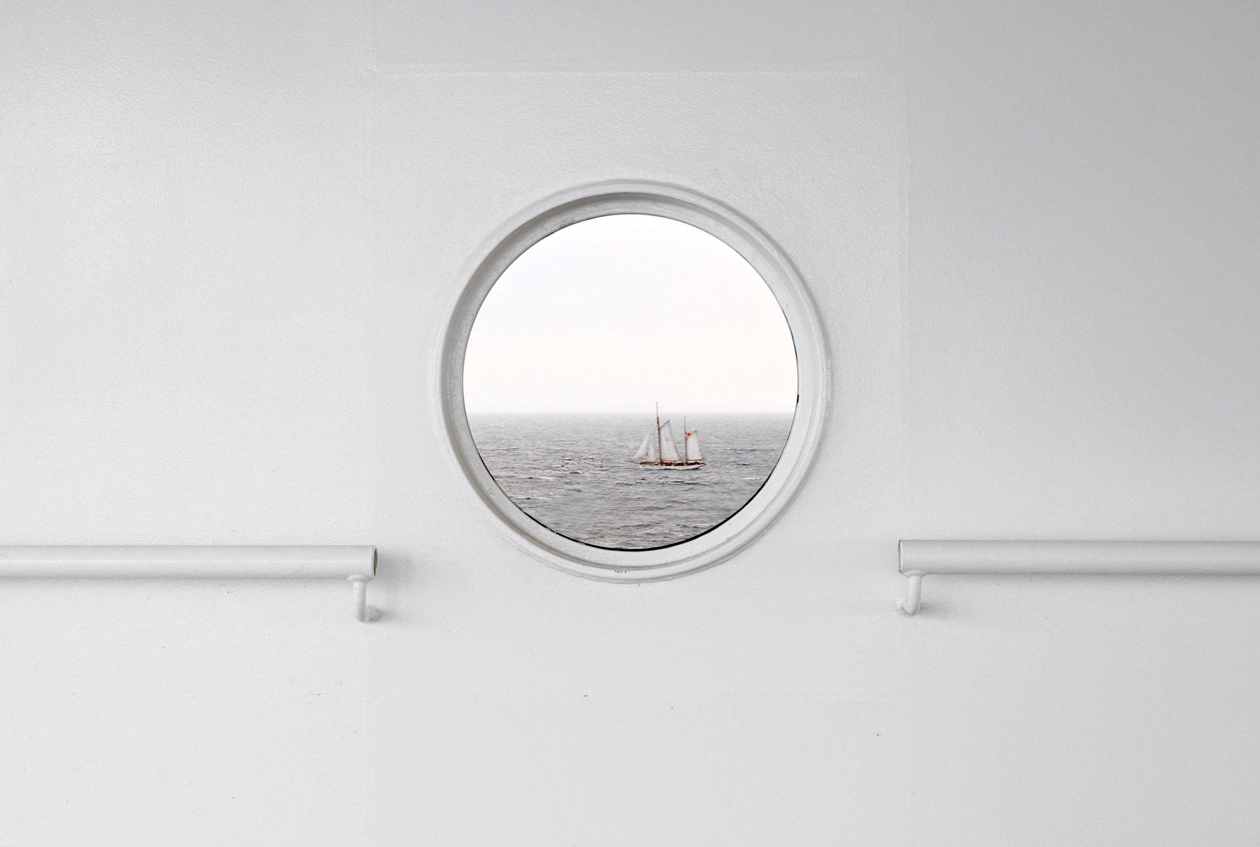 View of sailboat through circular window