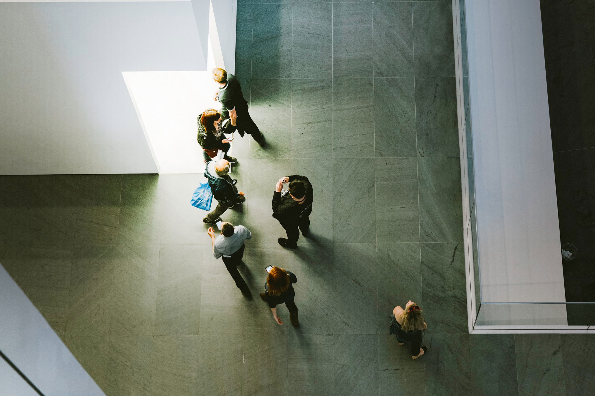 Overhead shot of people entering and exiting a doorway