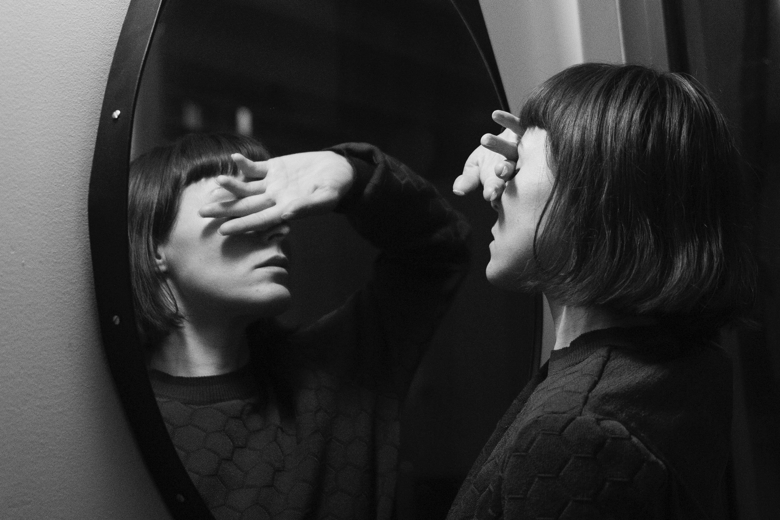 Woman looking into mirror