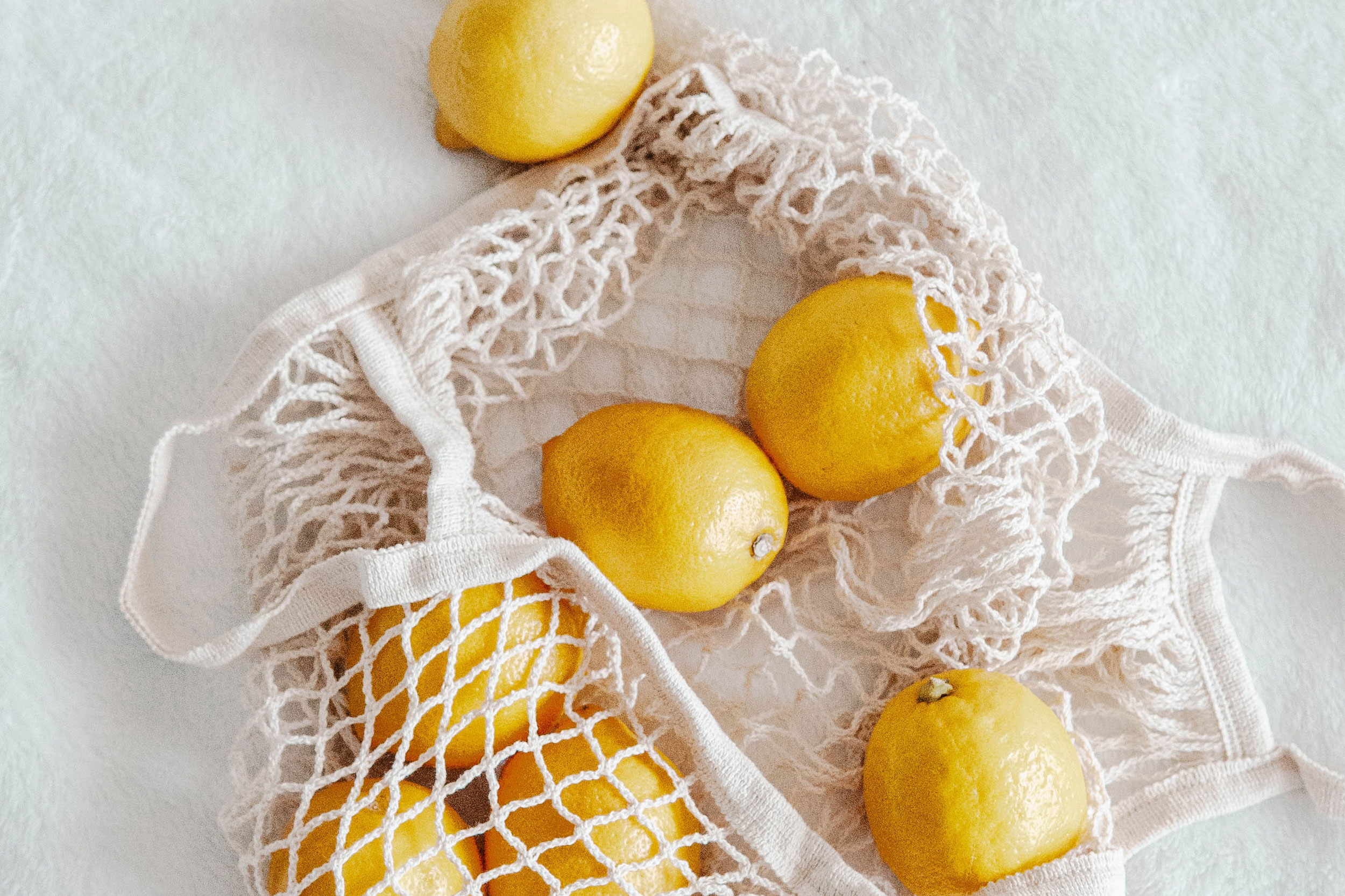 White mesh bag of lemons