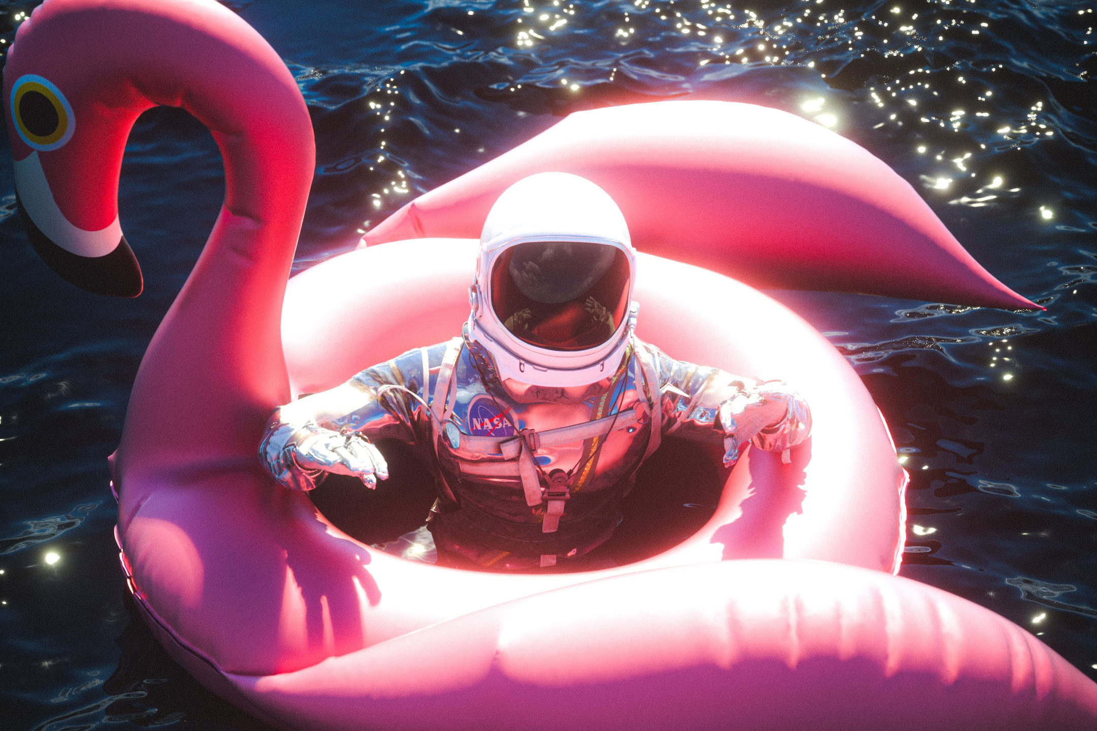 Astronaut in pool with inflatable flamingo