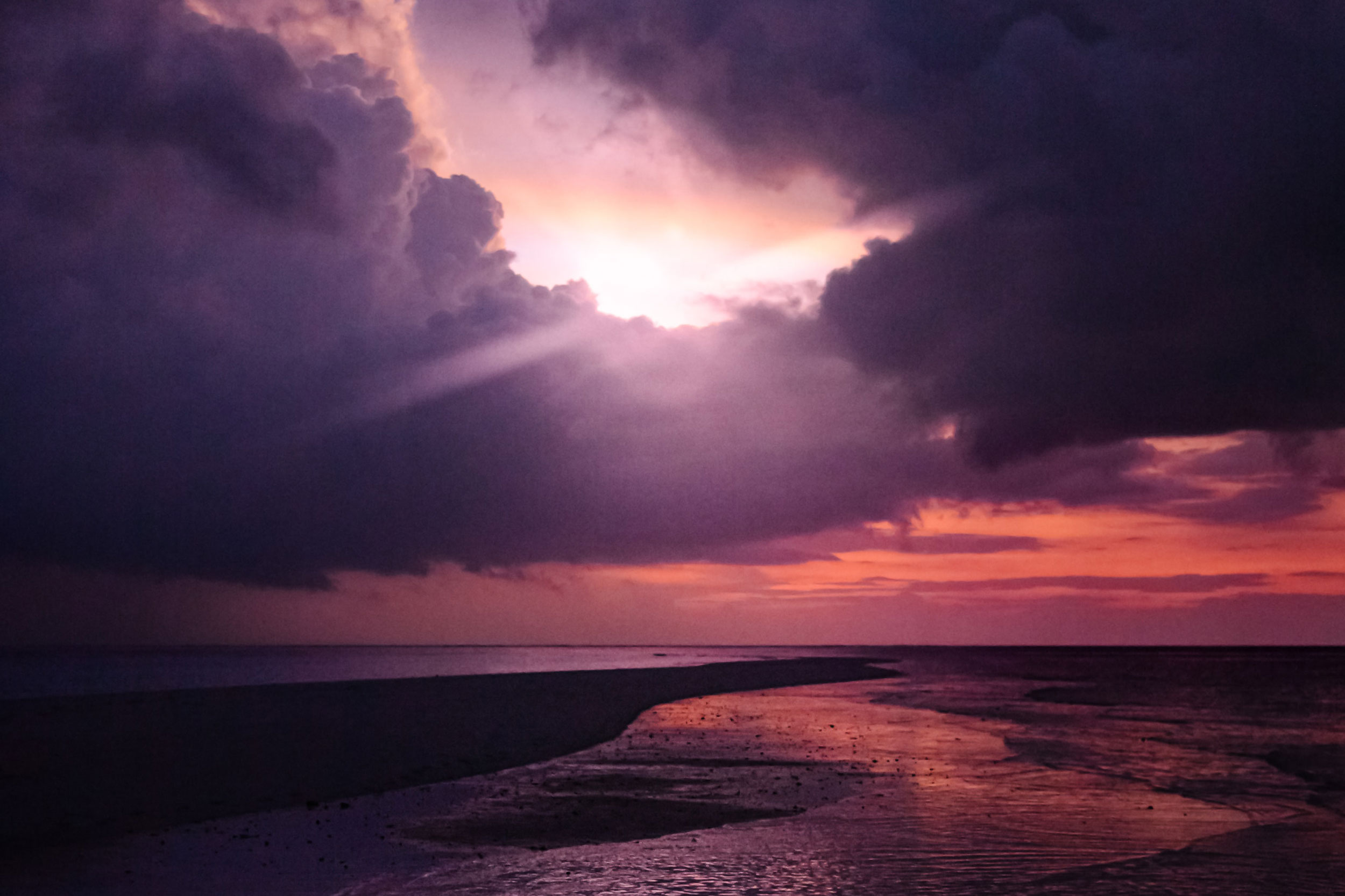 Dark purples and clouds at sunset on water