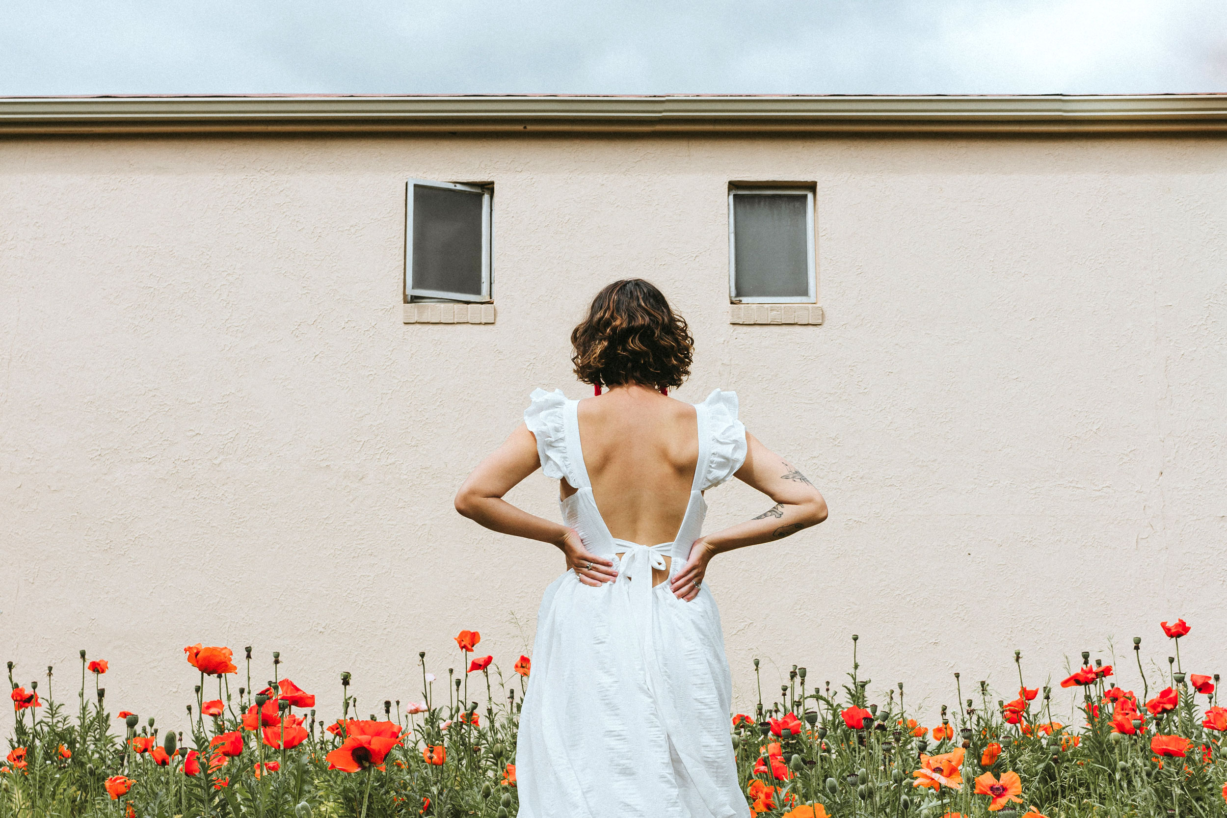 Woman in white dress with poppies